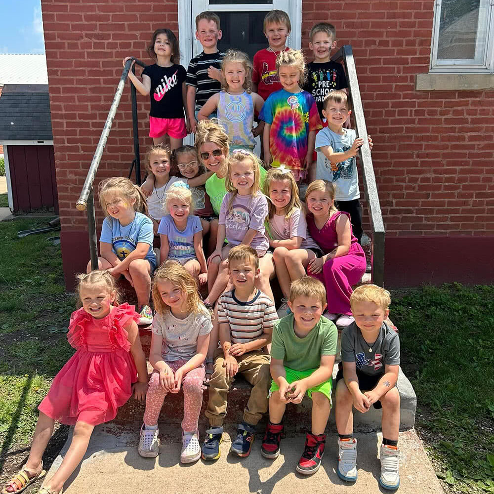 St. Mary Class sitting on steps outside